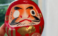 a small red daruma