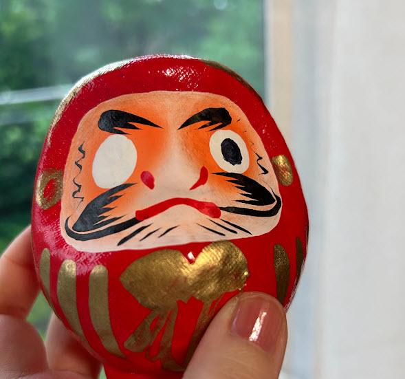 a small red daruma