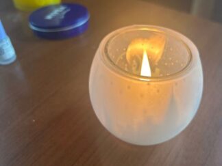 a candle in a candle holder cup