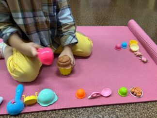 a kid playing ice cream shop