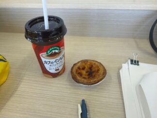 cafe latte and egg tart with documents