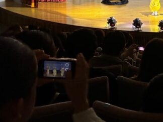 a kid holding a phone and taking photos